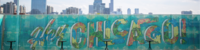 Image of Chicago skyline with the words Hey Chicago displayed across a fence line