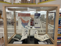 Photograph of display case with books featuring kingfishers and related birds.