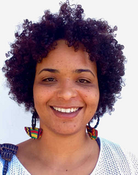 Picture of Priscila Ferreira, who has curly, dark hair