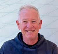 Picture of Dr. Ron Kopito. He has short, grey hair. He is wearing a blue hoodie and smiling.
