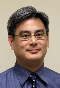 Picture of Dr. Vincent Lee. He has short, dark hair and wire-framed glasses. He is wearing a collared blue shirt and complementary blue and white tie.